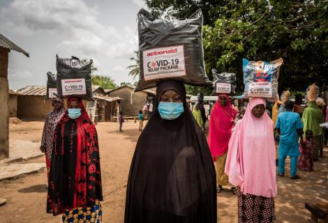 Women wearing face masks receive food support from ActionAid in Nigeria