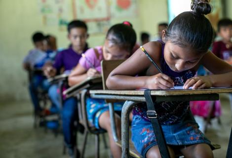 Students at the San Juan Villa Nueva School excitedly write their messages to their sponsors in the UK during Action Aid's annual message collection,